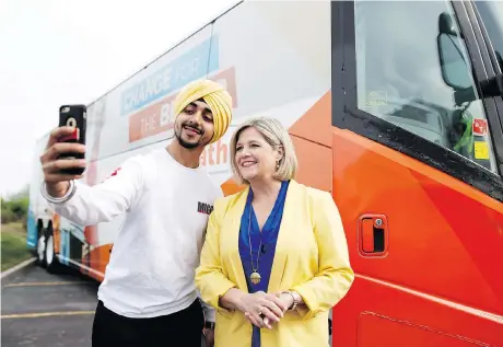  ?? COLE BURSTON/THE CANADIAN PRESS ?? Ontario NDP Leader Andrea Horwath takes a photo with a supporter during a campaign stop in Brampton on Saturday. As candidates seek office in Ontario they are more frequently turning to social media to engage with constituen­ts.