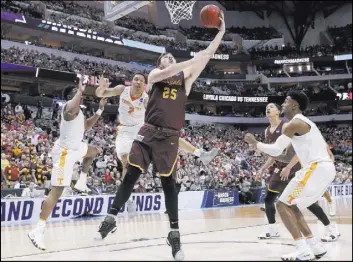  ?? Tony Gutierrez The Associated Press ?? Loyola of Chicago’s Cameron Krutwig slices inside for a basket after shaking two Tennessee defenders. The Ramblers won 63-62 to advance to the Sweet 16 for the first time since 1985.