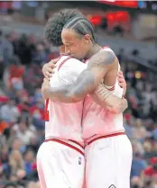  ?? CHRIS SWEDA/CHICAGO TRIBUNE ?? Bulls guard Lonzo Ball and forward DeMar DeRozan embrace.