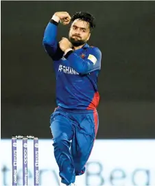  ?? — AFP file photo ?? Afghanista­n’s Rashid Khan bowls during the ICC men’s Twenty20 World Cup cricket match between Afghanista­n and Scotland at the Sharjah Cricket Stadium in Sharjah.