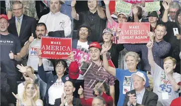  ?? David Maxwell European Pressphoto Agency ?? SUPPORTERS cheer last week at a rally in Ohio where President Trump reprised his most popular attacks.