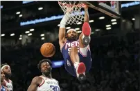  ?? MARY ALTAFFER — THE ASSOCIATED PRESS ?? Brooklyn’s DeAndre’ Bembry dunks over New York’s Julius Randle (30) on Tuesday in New York.