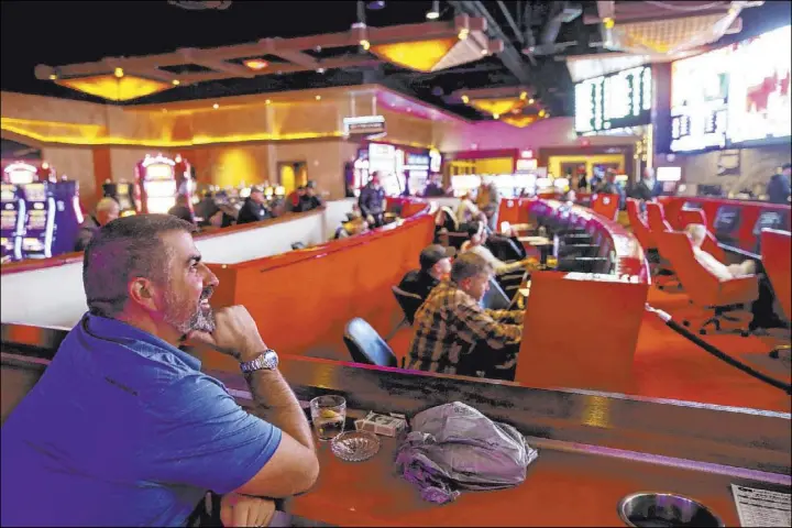  ?? K.M. Cannon Las Vegas Review-Journal @KMCannonPh­oto ?? Brian Miller, of Phoenix, watches games at the Silverton sportsbook Thursday. William Hill would acquire the casino’s sportsbook lease under a deal with CG Technology.