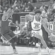  ?? TYLER HASTEDT/URI ATLETICS ?? Rhode Island’s Brandon Weston drives on a Fordham defender during Wednesday’s game.