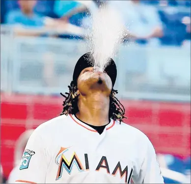  ?? CHARLES TRAINOR JR/MIAMI HERALD ?? Marlins pitcher Jose Urena spits water as he walks to the mound during a game in 2018, something that won’t be allowed in 2020.