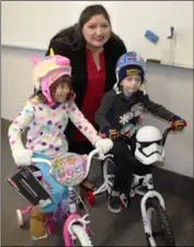  ?? PROVIDED BY CALIPATRIA STATE PRISON ?? Kindergart­eners Atreyu Atkisson and Lya Leon received new bicycles when Correction­al Counselor ii Gabriela Nunez, along with four staff members, made the trip to Grace Smith Elementary School in Niland recently. PHOTO