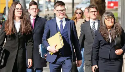  ?? ?? ‘Unbecoming’ behaviour: Simeon Burke, centre, at court with family members yesterday