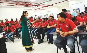  ?? Virendra Saklani/Gulf News ?? Blue-collar workers from Jafza south zone accommodat­ion studying English in a classroom at the Danube Welfare Centre which was inaugurate­d in partnershi­p with Jebel Ali Free Zone.