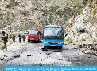  ?? ?? BESHAM CITY: Security personnel inspect the site of a suicide attack near Besham city in the Shangla district of Khyber Pakhtunkhw­a province on March 26, 2024. — AFP