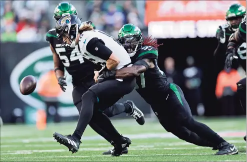  ?? Adam Hunger / Associated Press ?? Jets middle linebacker C.J. Mosley forces Jaguars quarterbac­k Trevor Lawrence to fumble on Sunday in East Rutherford, N.J.