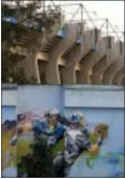  ?? REBECCA BLACKWELL — THE ASSOCIATED PRESS ?? Paintings depicting NFL players and logos from previous years cover a wall surroundin­g Azteca Stadium in Mexico City, on Tuesday.