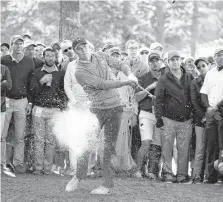  ??  ?? Jordan Spieth hits out of the rough on the 17th hole during the third round of the Masters on Saturday.