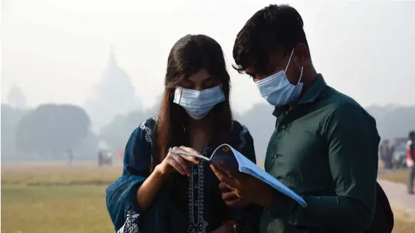  ?? EPA ?? People wear protective masks in Kolkata, India, on Saturday. India is among the countries where the JN.1 strand of the infection has been detected
