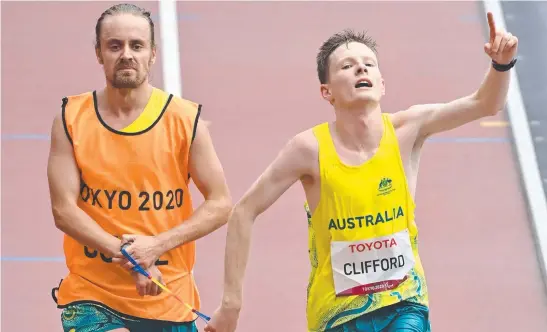  ?? Picture: AFP ?? Australia's Jaryd Clifford and his guide win the men's marathon T12 event during the Tokyo 2020 Paralympic Games.