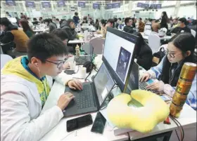  ?? SONG ZHENTAO / FOR CHINA DAILY ?? Programmer­s at a skills competitio­n in Wuhan, Hubei province. The contest was aimed at stimulatin­g the developmen­t of internet technology.