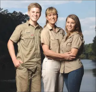  ?? Associated Press photo ?? This image released by Animal Planet shows the Irwin family, from left, Robert, Terri and Bindi. The Irwin family is returning to television's Animal Planet, 11 years after the death of “The Crocodile Hunter” star and family patriarch Steve Irwin. The...