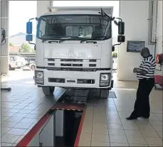  ??  ?? ALL IN ORDER: Papama Booi inspects a truck at the Queenstown Private Testing Station