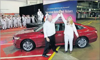  ?? [ADAM CAIRNS/DISPATCH] ?? Ray Mikiciuk, Honda’s assistant vice president for sales, and Honda engineer Pam Buchanan celebrate the redesigned 2018 Accord sedan at the Marysville assembly plant in September. The Accord has been the plant’s main product since it opened in 1982.