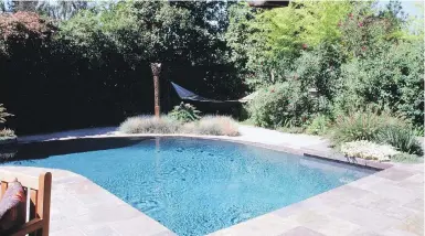  ??  ?? Naturally tall shrubs, bamboo and evergreen background trees screen the pool and the separate hammock for private rest and reflection.