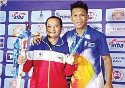  ?? (ABAP Images) ?? EumIr Felix Marcial, right, with coach Boy Velasco.