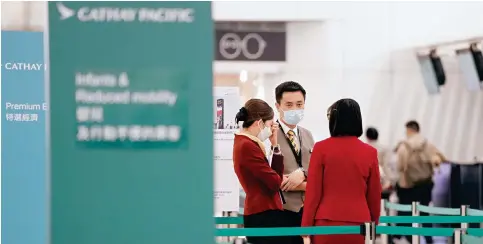  ?? Photo: Sam Tsang ?? Staff from Cathay Pacific in the departure area of Hong Kong Internatio­nal Airport in Chek Lap Kok yesterday.