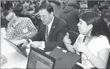  ?? PHOTO BY HOWARD FISCHER/CAPITOL MEDIA SERVICES ?? HARRISON KERKHOFF AND ELIGIA (ELLIE) DE LA CRUZ HELP GOV. DOUG DUCEY complete a coding task. Ducey visited the Phoenix Coding Academy Monday to praise what is being taught even though none of the funds came from the state.