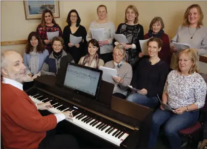 ??  ?? The DoMiSo choir rehearsing with their musical director Frank Kelly at the Stables in Delgany.