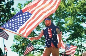  ?? Hearst Connecticu­t Media file photo ?? John DiCarlo waves a giant American flag from atop the Derby Little League float during the Derby Shelton Memorial Day Parade in 2019.