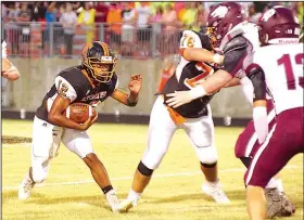  ?? Special to NWA Democrat-Gazette/RANDY MOLL ?? Gravette quarterbac­k Tajae White (12) looks for an opening in the Lincoln defense Friday in Gravette.