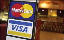  ?? MARK LENNIHAN — THE ASSOCIATED PRESS ?? Visa and MasterCard announced a settlement with U.S. merchants related to swipe fees, which are typically 2% of a purchase.