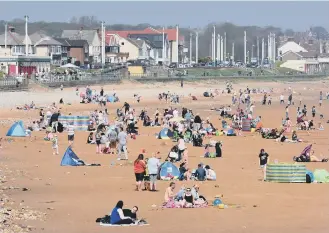  ??  ?? People taking advanatge of the glorious weather on the beach at Seaburn.