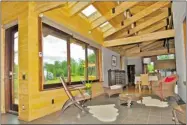  ??  ?? The bright, open interior features wood walls reclaimed from an old A-frame building on the property.