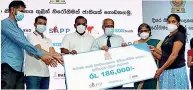  ??  ?? Symbolic presenting of a loan facility to an entreprene­ur by SDB bank