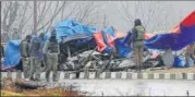  ?? HT FILE ?? Security personnel inspect the blast site in Lethpora on Friday.