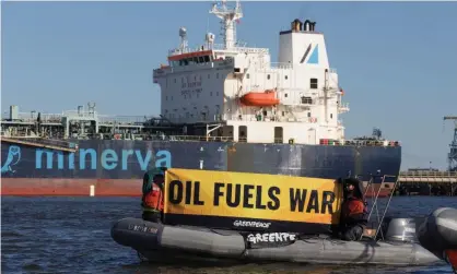  ?? Photograph: Bjoern Kils/Reuters ?? Activists protest near oil tanker Minerva Virgo docked at Bayonne, New Jersey.