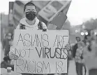  ?? DAMIAN DOVARGANES/ AP ?? A demonstrat­or participat­es at a rally “Love Our Communitie­s: Build Collective Power” to raise awareness of anti- Asian violence outside the Japanese American National Museum in Little Tokyo in Los Angeles on March 13, 2021.