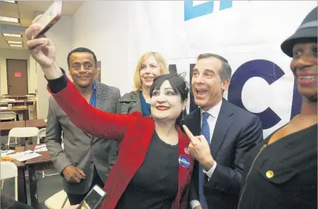  ?? Mark Boster Los Angeles Times ?? MAYOR ERIC Garcetti, center, takes a selfie with volunteers at his campaign office. Though Garcetti is the clear front-runner, getting reelected by a huge margin over 10 obscure rivals also would enhance his dominance of L.A. politics and his dealings...