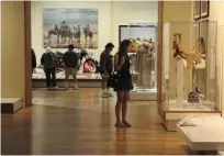  ??  ?? Museums guests examine artwork in one of the museum’s galleries.