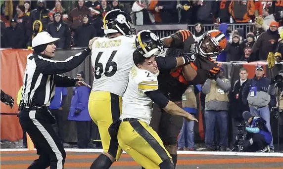  ?? AP ?? SHOCKING STUFF: Myles Garrett was suspended through at least the end of the season for hitting Mason Rudolph with a helmet in the final seconds of Thursday night’s game won by Cleveland, 21-7.