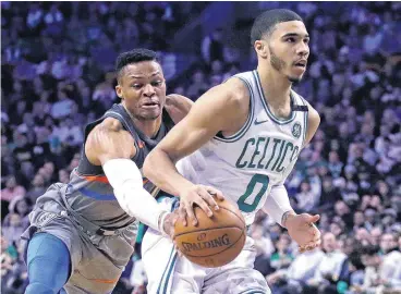  ??  ?? Oklahoma City Thunder guard Russell Westbrook, left, strips the ball from behind on a drive to the basket by Boston Celtics forward Jayson Tatum. The Celtics won, 100-99.