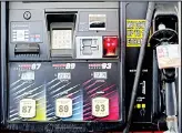  ??  ?? In this file photo, gasoline prices are displayed on a pump at Sheetz along the Interstate 85 and 40 corridor near Burlington, N.C. America’s rediscover­ed prowess in oil production is shaking up old notions about the impact of higher crude prices on the US economy. (AP)