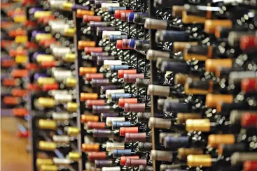  ?? AP Photo/Rick Bowmer ?? ■ Bottles of wine are displayed during a tour of a state liquor store on June 16, 2016, in Salt Lake City. The tariffs the Trump administra­tion is about to impose on wine, liquor and cheese from Europe couldn’t come at a worse time for small retailers.