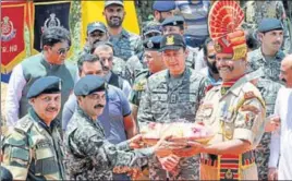  ?? NITIN KANOTRA/HT ?? Border Security Force personnel receives sweets from the Pakistani army during the ancient shrine of Dalip Singh Baba Chamliyal annual fair at the internatio­nal border in Ramgarh sector, about 45 km from Jammu, on Thursday.