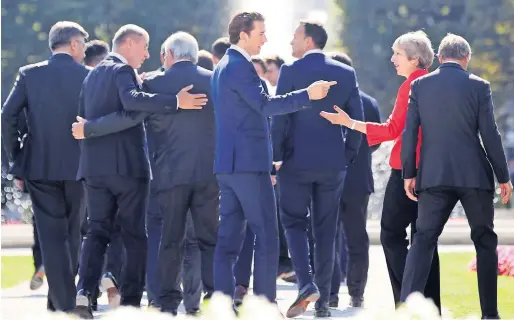  ?? Reuters ?? Austrian Chancellor Sebastian Kurz and Britain’s Prime Minister Theresa May arrive for a family photo during the EU leaders informal summit in Salzburg. —