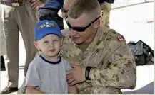  ?? ?? Top: MSE OP Bryce Hooper at Camp Mirage, U.A.E., in 2006. Above: A tender moment with his son, Xavier; armed and at the ready.