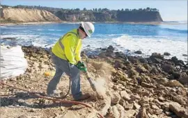  ?? Patrick T. Fallon For The Times ?? A WORKER uses a jackhammer to demolish the stone “fort” at Lunada Bay.