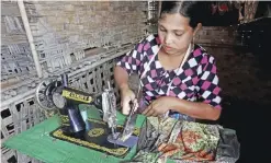  ??  ?? MYANMAR: This photo shows a Muslim woman sewing machine at her room in Da Paing IDP camp near Sittwe town in Rakhine state. — AFP