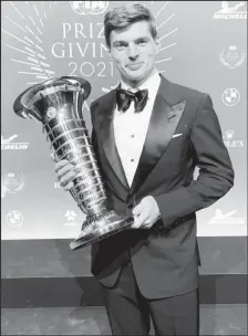  ?? ?? Max Verstappen posing with the Formula One world championsh­ip trophy