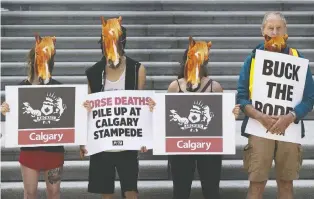  ?? GREG SOUTHAM ?? PETA supporters wearing horse masks protest the Calgary Stampede chuckwagon races in front of the Alberta Legislatur­e on July 16. Actress Pamela Anderson, an honorary PETA director, wrote to Premier Jason Kenney urging him to ban the event.