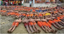  ?? — PTI ?? Devotees perform rituals as they celebrate the annual tribal festival of “Manda Puja” at a Shiva temple in Ranchi on Monday. They believe performing these ritual brings rain and fulfill their wishes.